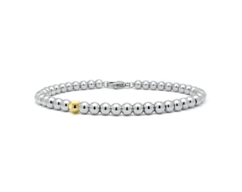4mm beaded bracelet with a single gold bead in stainless steel