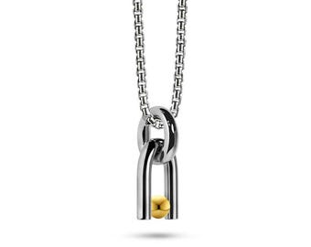 DIAPASON shaped tubular pendant with tension set Gold sphere in stainless steel