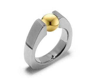 PYRAMID Triangular shaped ring with a tension set gold sphere in stainless steel