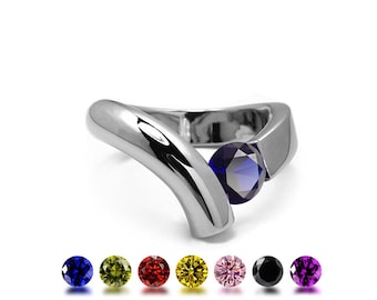 ONDE Flat and rounded tubular bypass ring with tension set colored gemstone in stainless steel