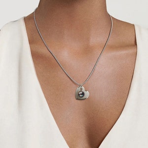 CUORE open hart pendant with black pearl dangling in the center in stainless steel by Taormina Jewelry image 3