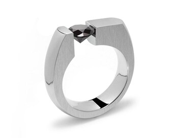 COLONNA Flat top ring with a off centered tension set Black Diamond in stainless steel