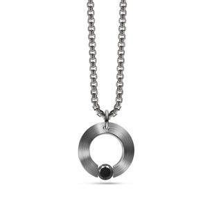 May include: A silver chain necklace with a circular pendant featuring a black diamond in the centre.