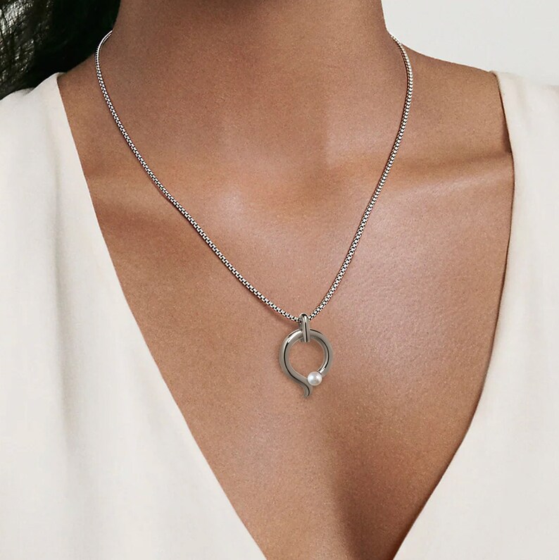 ONDE teardrop tubular pendant with tension set white pearl in stainless steel by Taormina Jewelry image 2