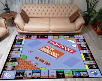 May include: A rectangular rug featuring a Super Mario Bros. Monopoly game board design. The rug has a light blue background with game elements and text in red, orange, and black. The rug is placed on a light-colored wooden floor.