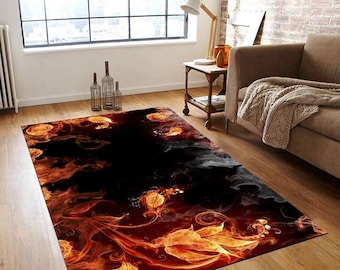 May include: A black and orange area rug with a floral design. The rug features a swirling pattern of orange and yellow flowers on a black background.