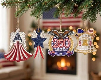 May include: Four patriotic hanging ornaments featuring an angel with American flag wings, a blue star with red and white rays, a 250th anniversary emblem with an eagle and the text 1776-2026 AMERICA, and a bell with a flag pattern and Liberty Bell icon.