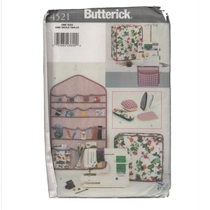 May include: Butterick 4521 sewing pattern envelope featuring illustrations of a wall-mounted organizer with red and white stripes, a floral print sewing machine cover, a matching storage bag, a pincushion, an iron rest, and a sewing machine.