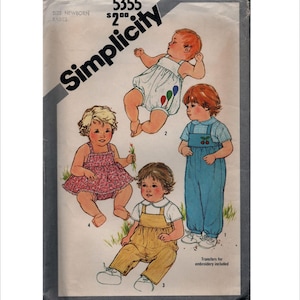 May include: A Simplicity 5355 sewing pattern envelope for newborn babies. The cover features illustrations of four infants wearing various outfits: a balloon-print romper, a floral dress, blue overalls with a cherry motif, and yellow overalls.