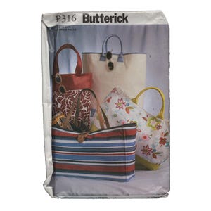 May include: A pattern envelope for Butterick P316 featuring images of various tote bags. The bags showcase diverse designs, including striped, floral, and solid colors. The bags have handles and some have decorative elements.