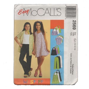 May include: McCall's 2569 sewing pattern envelope for children's clothing, size CJ (10-12-14). The front displays illustrations of a short-sleeved button-down shirt, a sleeveless dress, and pants. Text includes Easy McCall's, 2569, and KidStuff.