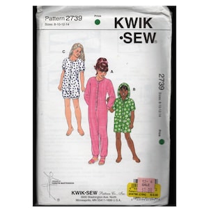May include: A Kwik Sew sewing pattern, number 2739, featuring illustrations of three different sleepwear designs. The pattern includes sizes 8-10-12-14. The sleepwear options include a pink jumpsuit, a green hooded romper, and a white romper with black polka dots.