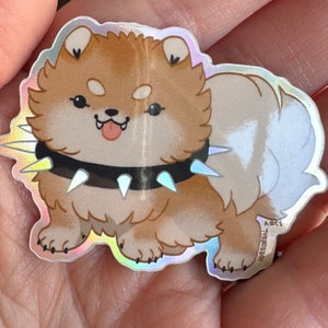A photo of the sticker in the palm of a hand for scale. It's quite small.