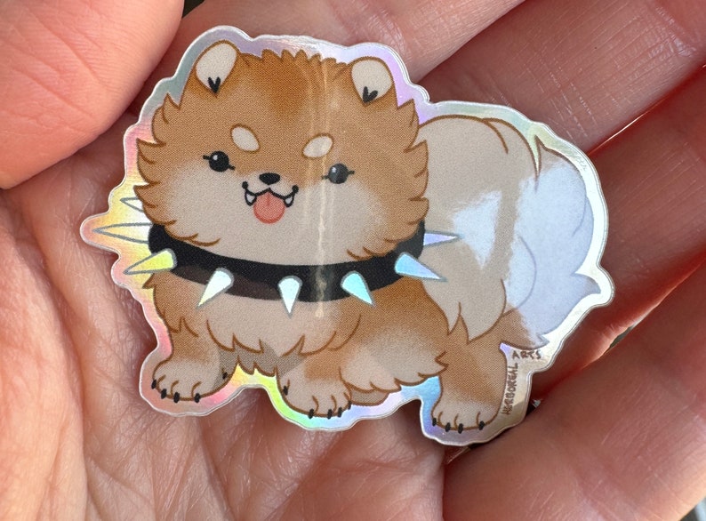 A photo of the sticker in the palm of a hand for scale. It's quite small.