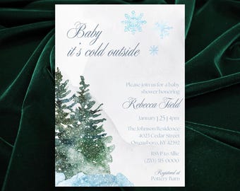 May include: A baby shower invitation with a winter theme. The invitation features a watercolour illustration of snow-covered trees and mountains. The text reads "Baby it's cold outside" and includes the details of the shower, including the date, time, location, and RSVP information. The invitation is registered at Pottery Barn.