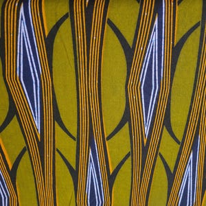 May include: Abstract fabric with a pattern of black, orange, and white lines on a green background.