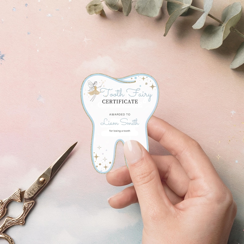 May include: A tooth-shaped Tooth Fairy Certificate with a pale blue border and gold accents. The certificate includes the text "Tooth Fairy Certificate" and "Awarded to Liam Smith for losing a tooth."
