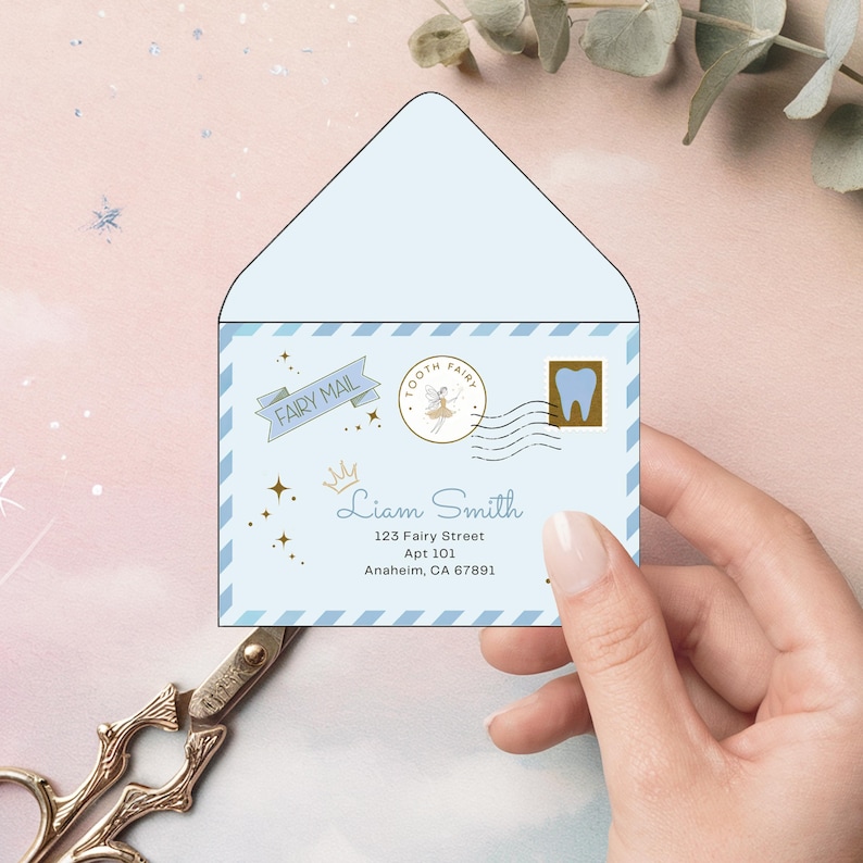 May include: A pale blue envelope with a Tooth Fairy design. The envelope features a banner reading "FAIRY MAIL", a Tooth Fairy stamp, and a gold tooth stamp. The address reads "Liam Smith, 123 Fairy Street, Apt 101, Anaheim, CA 67891".
