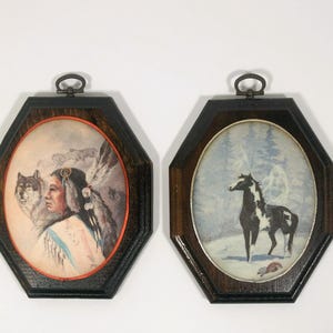 May include: Two framed pictures with dark wood frames. The picture on the left shows a Native American woman with a wolf. The picture on the right shows a black and white horse in a snowy forest.