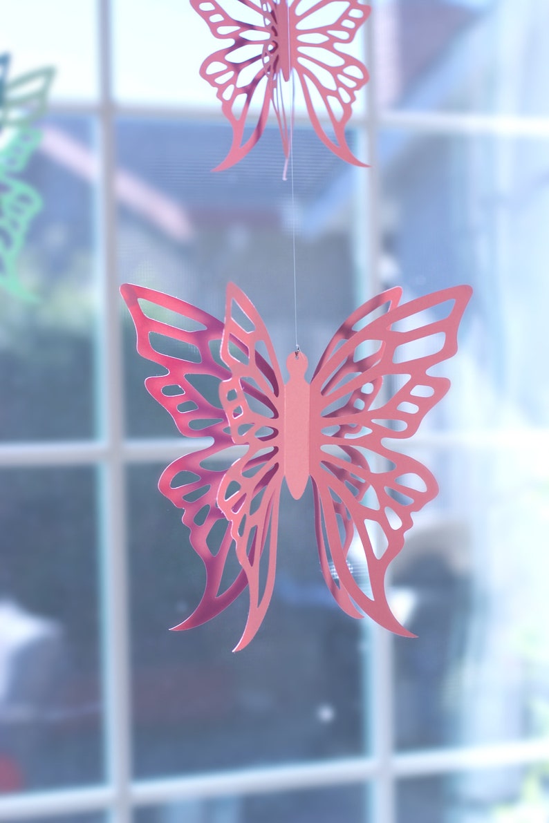 Pink Paper Butterfly Hanging in front of window