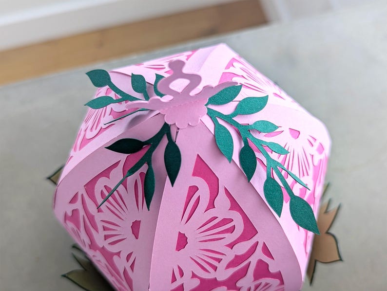 Close up of the top of Easter egg craft, showing paper leaves.
