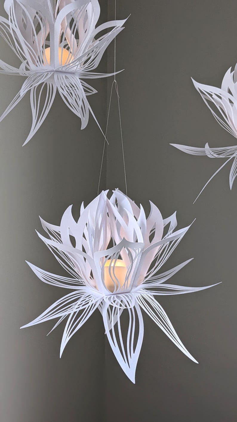 White paper lotus lantern hanging with soft LED light inside