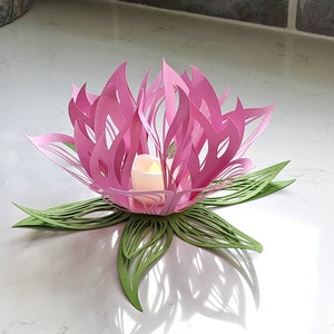 Pink paper lotus lantern centerpiece with LED candle on table, flower light decor with green leaf base