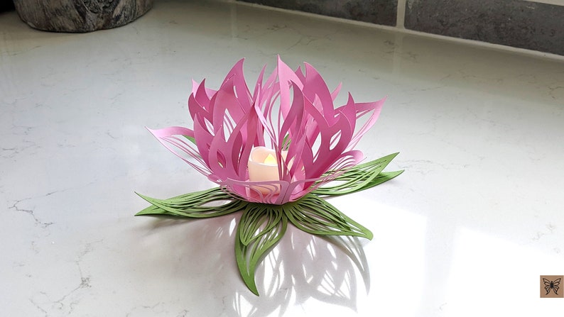 Pink paper lotus lantern centerpiece with LED candle on table, flower light decor with green leaf base