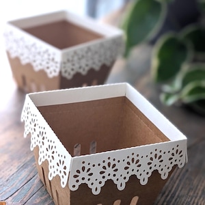 Lace berry basket made from kraft cardstock with white lace edge detail, empty paper treat box styled on wooden table