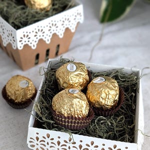 Lace berry basket filled with chocolates and paper grass, kraft cardstock treat box with white lace edge detail