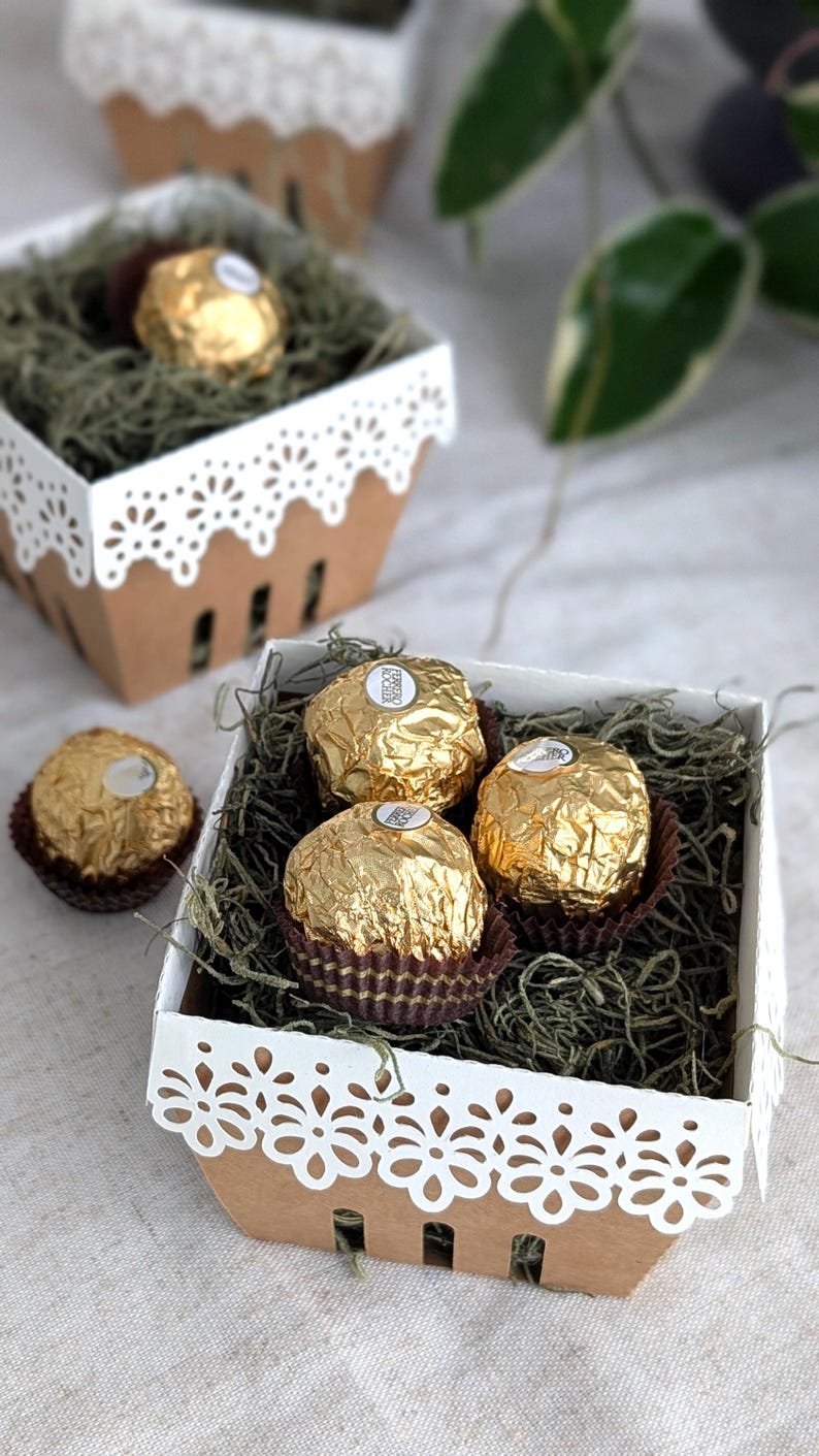 Lace berry basket filled with chocolates and paper grass, kraft cardstock treat box with white lace edge detail