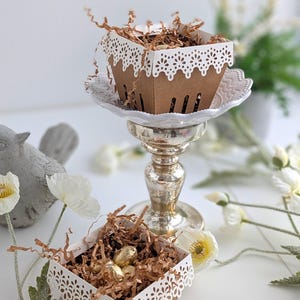 Lace berry baskets styled as table decor with kraft cardstock and white lace edging, filled with treats and displayed on pedestal