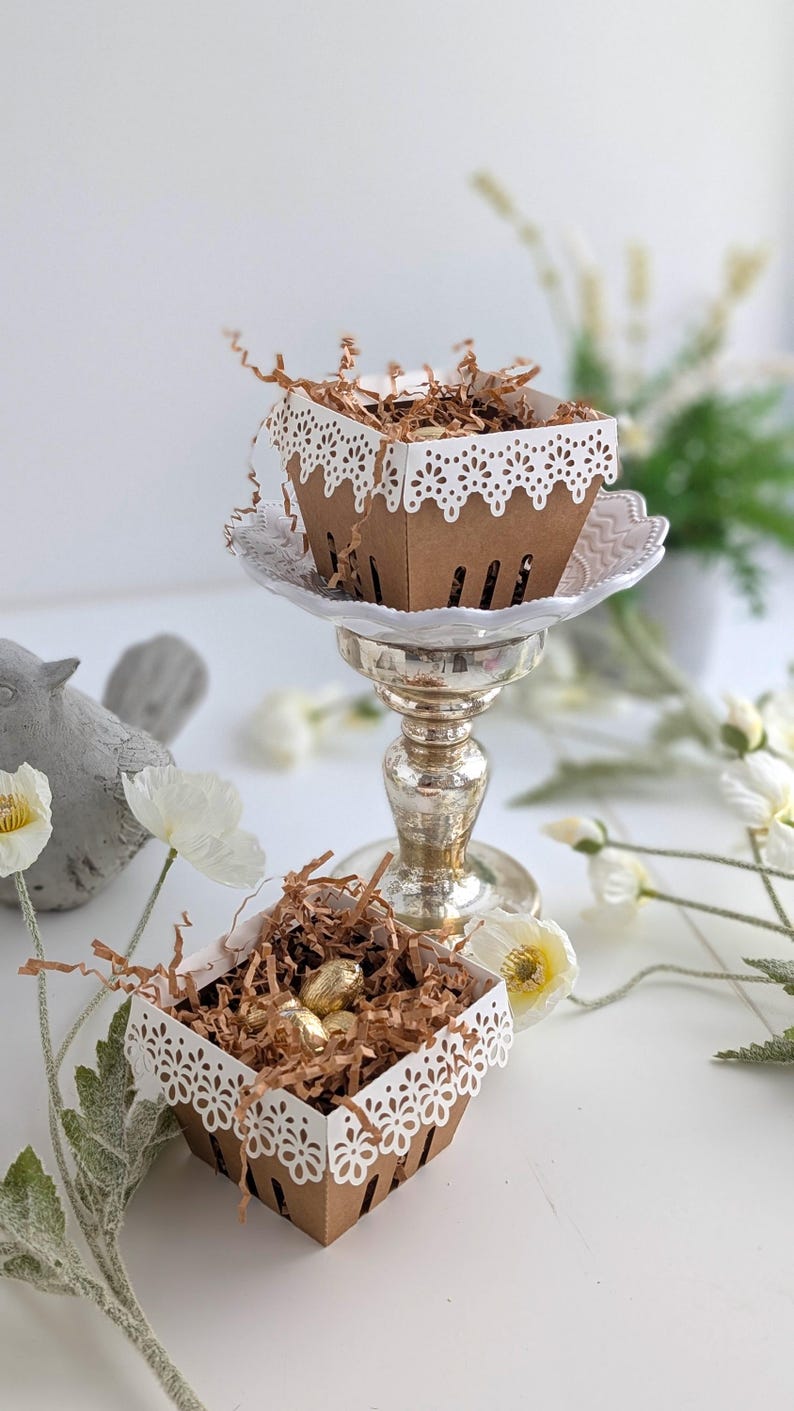 Lace berry baskets styled as table decor with kraft cardstock and white lace edging, filled with treats and displayed on pedestal