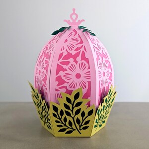 Floral Easter egg basket decor in pink displayed in a decorative leaf base, styled as a spring table centerpiece and Easter home accent.