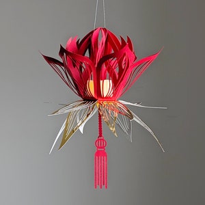 Red 3D paper lotus lantern with gold accents and tassel, made from an SVG file for Cricut; hanging Lunar New Year flower decor.