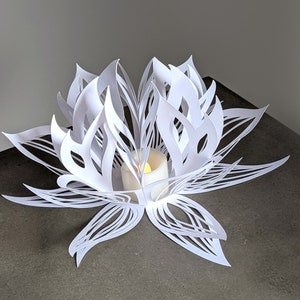 White paper lotus lantern used as LED tealight centerpiece on table
