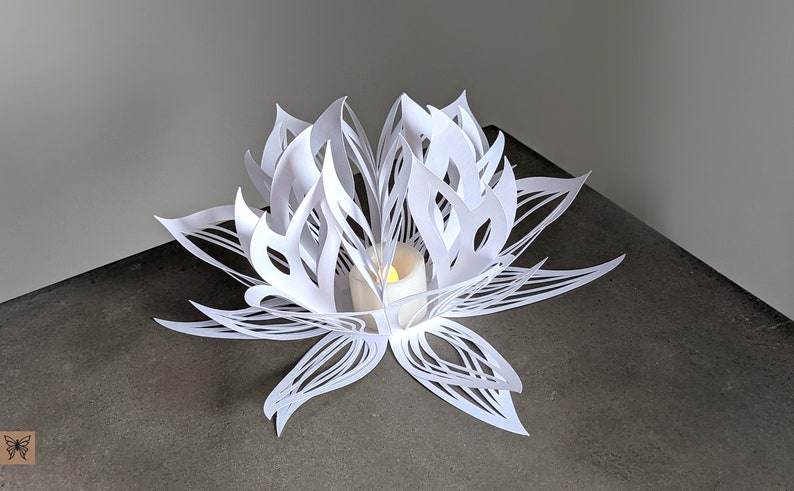 White paper lotus lantern used as LED tealight centerpiece on table