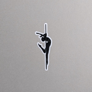 May include: Black silhouette of a person performing a pole dance move on a pole.