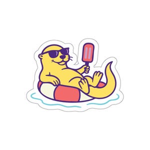 May include: A yellow cartoon otter wearing sunglasses and floating on a red and white inner tube, holding a popsicle. The otter is in a relaxed pose, with a light blue water line below. The sticker has a white border.