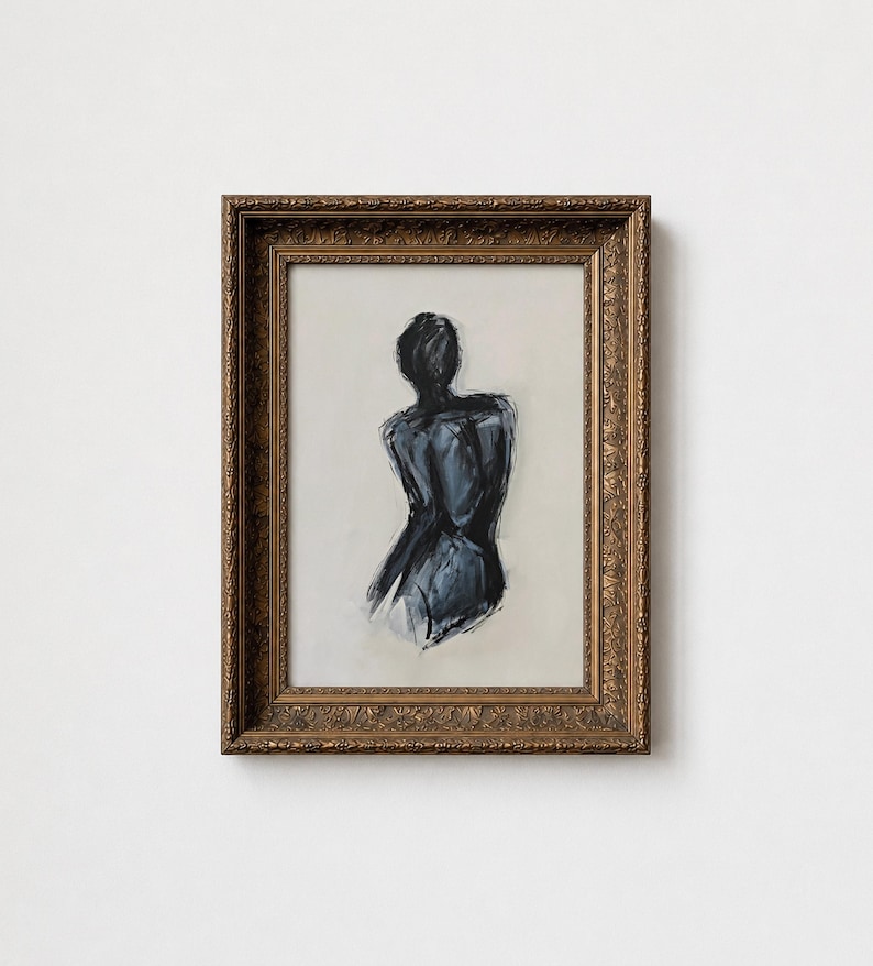 May include: An abstract painting of a figure in a dark blue hue, viewed from the back. The artwork is framed in a gold-colored, ornate frame. The background is a light beige color.