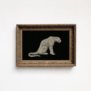 May include: A rectangular wall art piece featuring a detailed illustration of a spotted leopard in profile, set against a solid black background. The artwork is enclosed in an ornate, antique-style gold frame with intricate relief carvings.