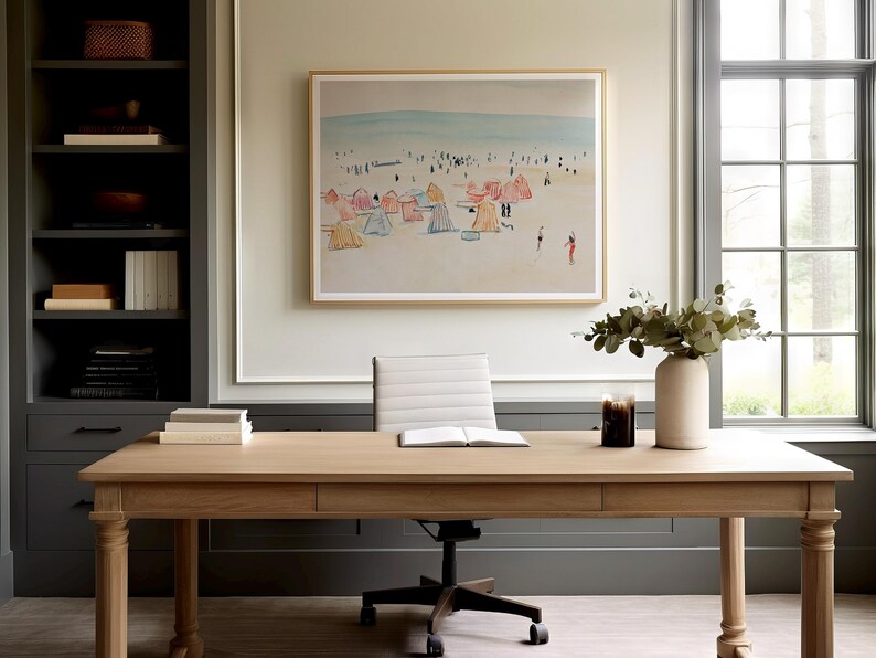 May include: A light wood desk with a white office chair, a framed beach scene painting, and a vase with green leaves and a white vase on top of the desk.