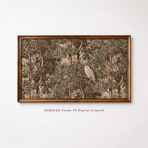 May include: A rectangular Samsung Frame TV digital artwork featuring a detailed forest scene with dense green foliage, brown tree trunks, and a white owl perched on a branch, all enclosed within a dark brown wooden frame with the text SAMSUNG Frame TV Digital Artwork.