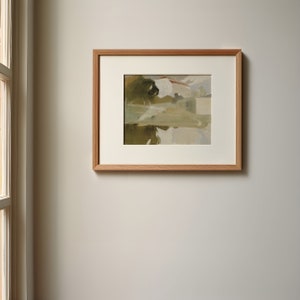 May include: A framed painting of a landscape with a white building and a tree reflected in a body of water.