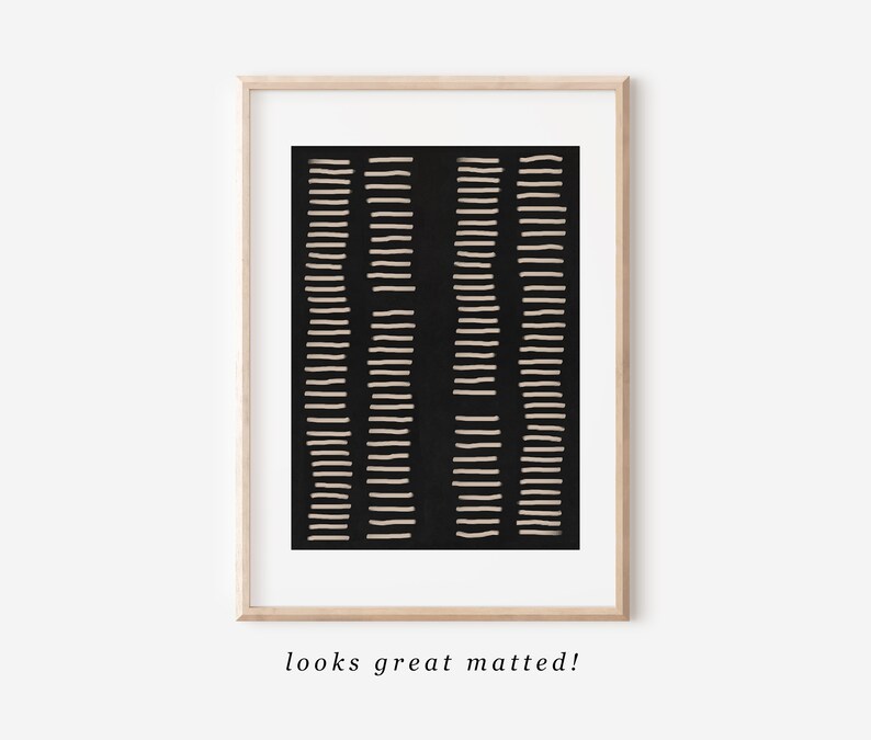 May include: A black and white abstract art print with a geometric pattern of thin lines. The print is framed in a light wood frame.