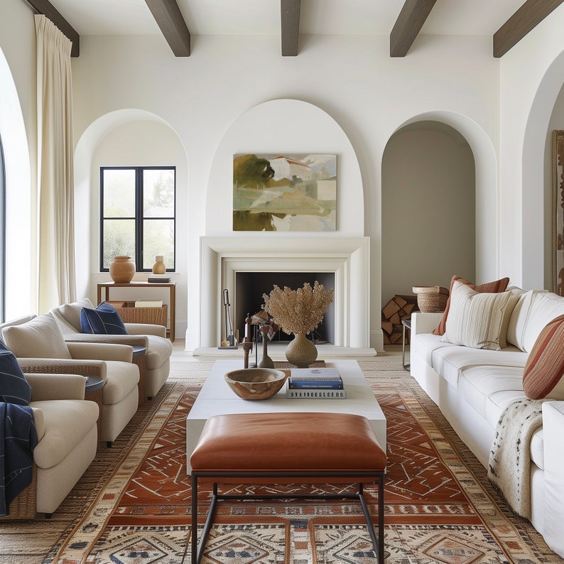May include: A living room with a white sofa, two armchairs, a coffee table, and a fireplace. The room has a white and brown color scheme and features a large rug with a geometric pattern.
