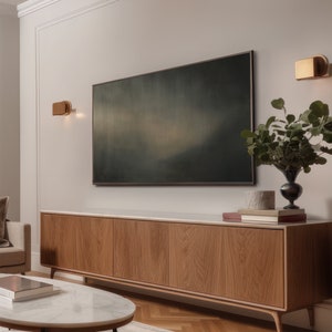 May include: A modern living room with a wooden cabinet, a white marble coffee table, and a large abstract painting above the cabinet. Two gold wall sconces are on either side of the painting.