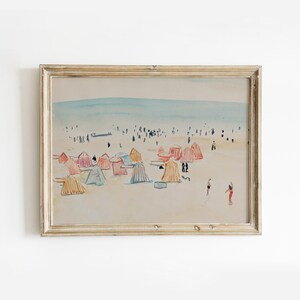 May include: A watercolor painting of a beach scene with colorful beach umbrellas and people in the distance. The painting is framed in a light wood frame.