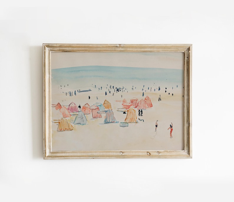 May include: A watercolor painting of a beach scene with colorful beach umbrellas and people in the distance. The painting is framed in a light wood frame.