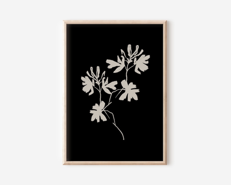 May include: A black and white minimalist art print featuring a stylized floral design with beige flowers and stems on a black background.